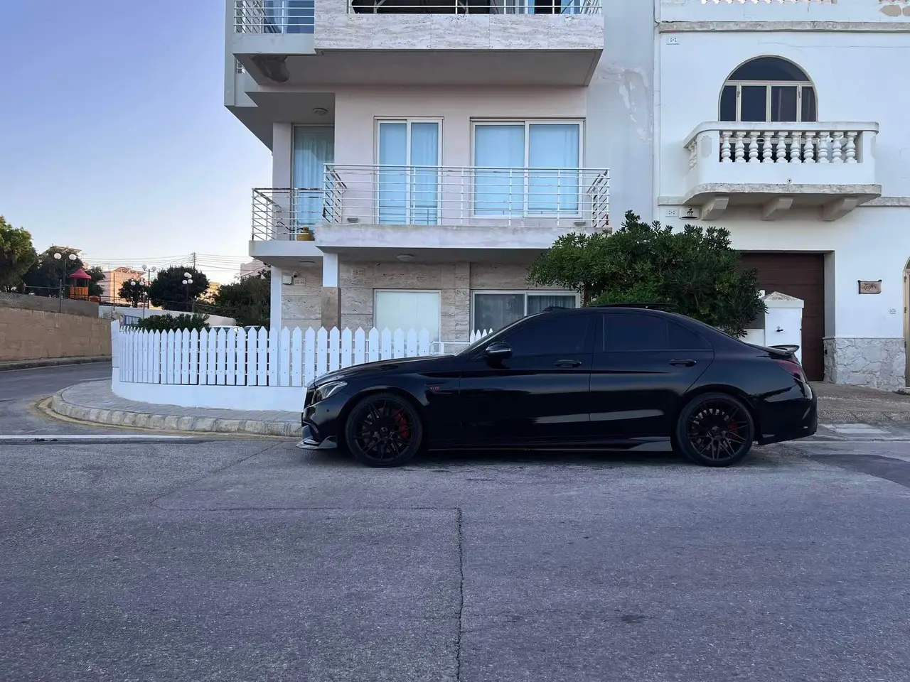 Black performance saloon photographed on a Maltese street